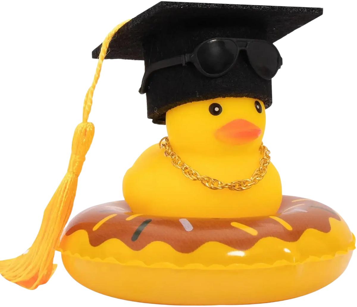 Yellow rubber duck car dashboard ornament wearing black graduation cap sunglasses and gold chain on donut float