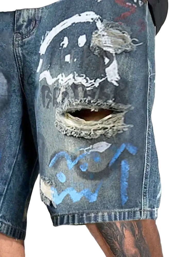 Distressed blue denim shorts for men with white and light blue graffiti-style graphic and intentional rips