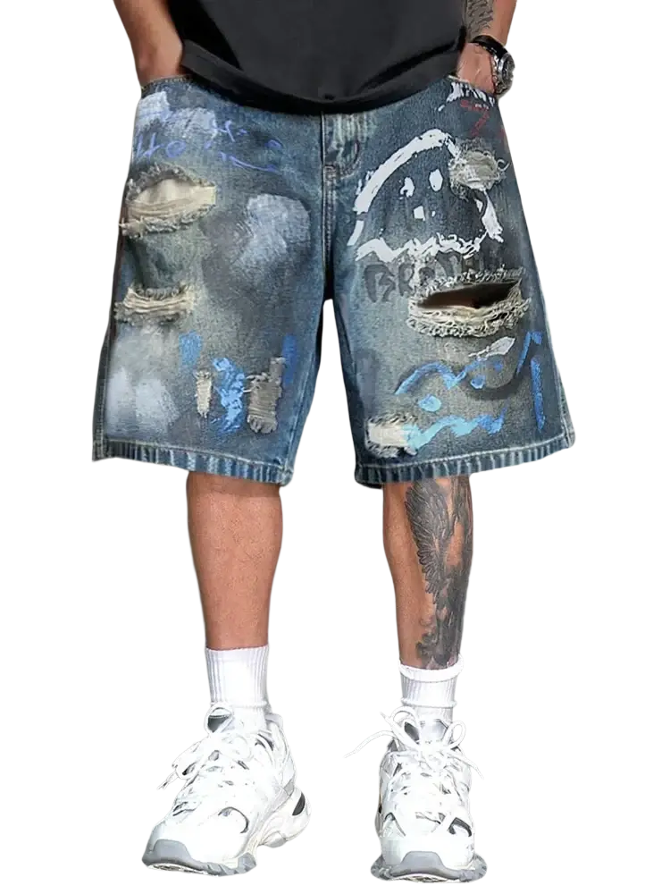 Graffiti distressed denim shorts in blue with ripped knees and cosmic paint splatter design for men