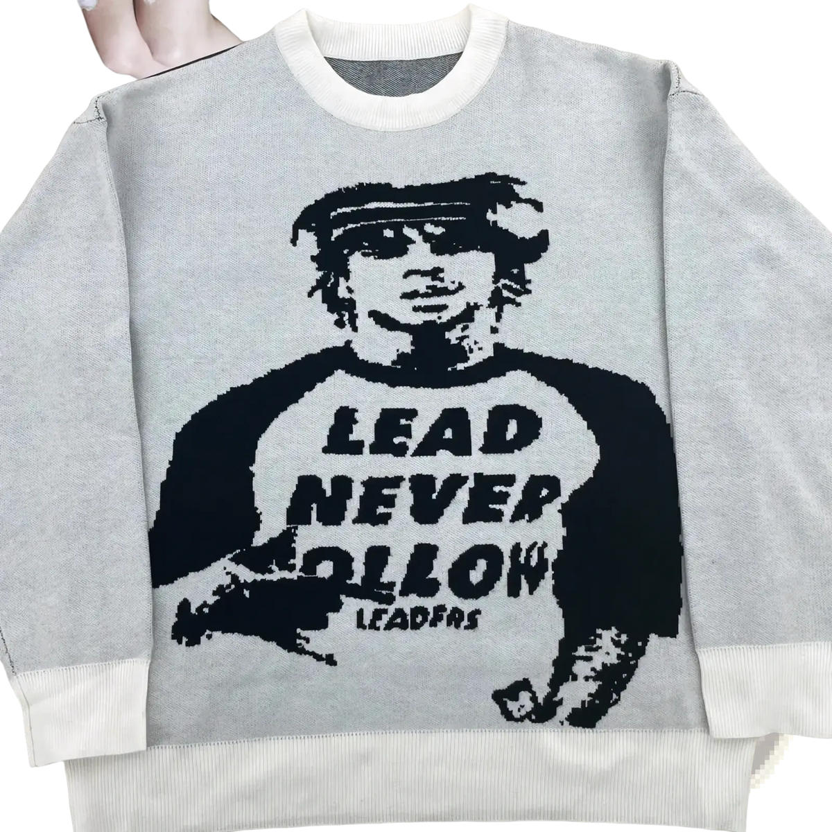 Gray knit sweater featuring a black knitted graphic of a person with sunglasses and lead never follow text in y2k streetwear style