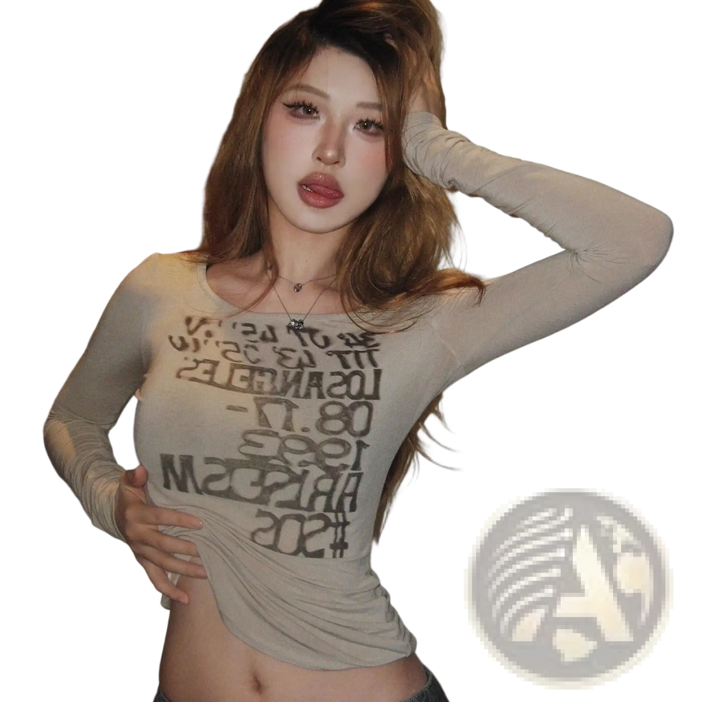Beige graphic letter print long sleeve crop top made of sheer stretchy fabric with bold black graffiti lettering
