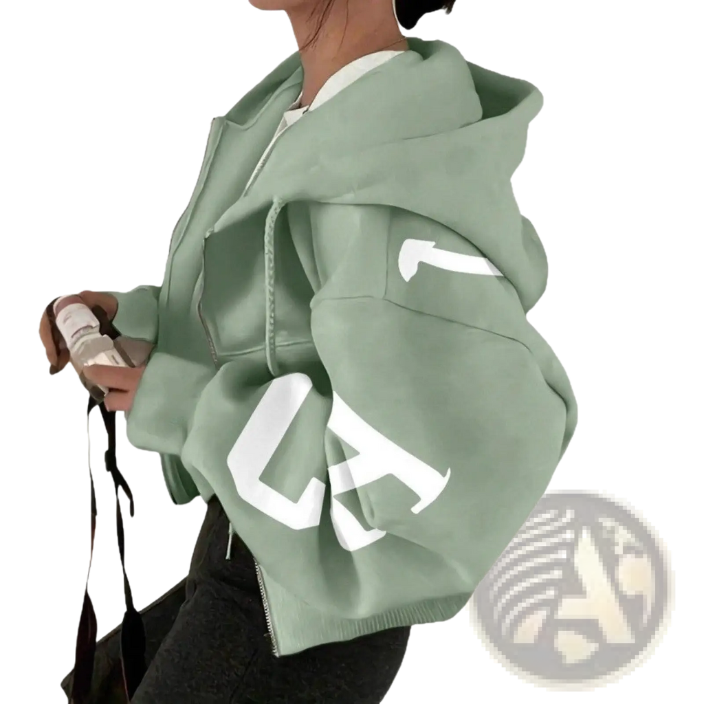 Mint green cropped graphic print zip up sweatshirt with bold white lettering on the sleeves in cotton blend material