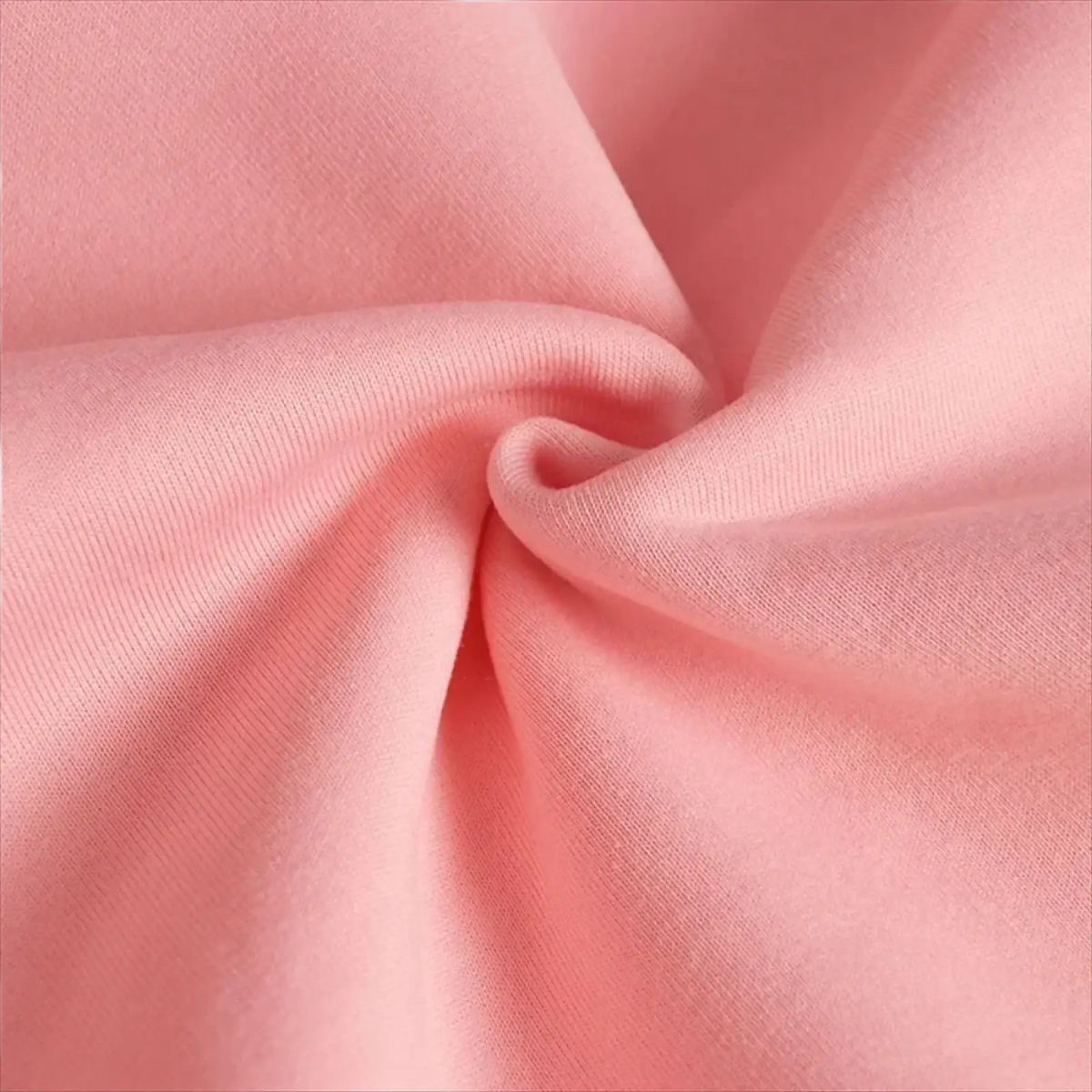 Soft pink knit fabric of graphic pullover hoodie featuring a smooth textured surface for casual sportswear use