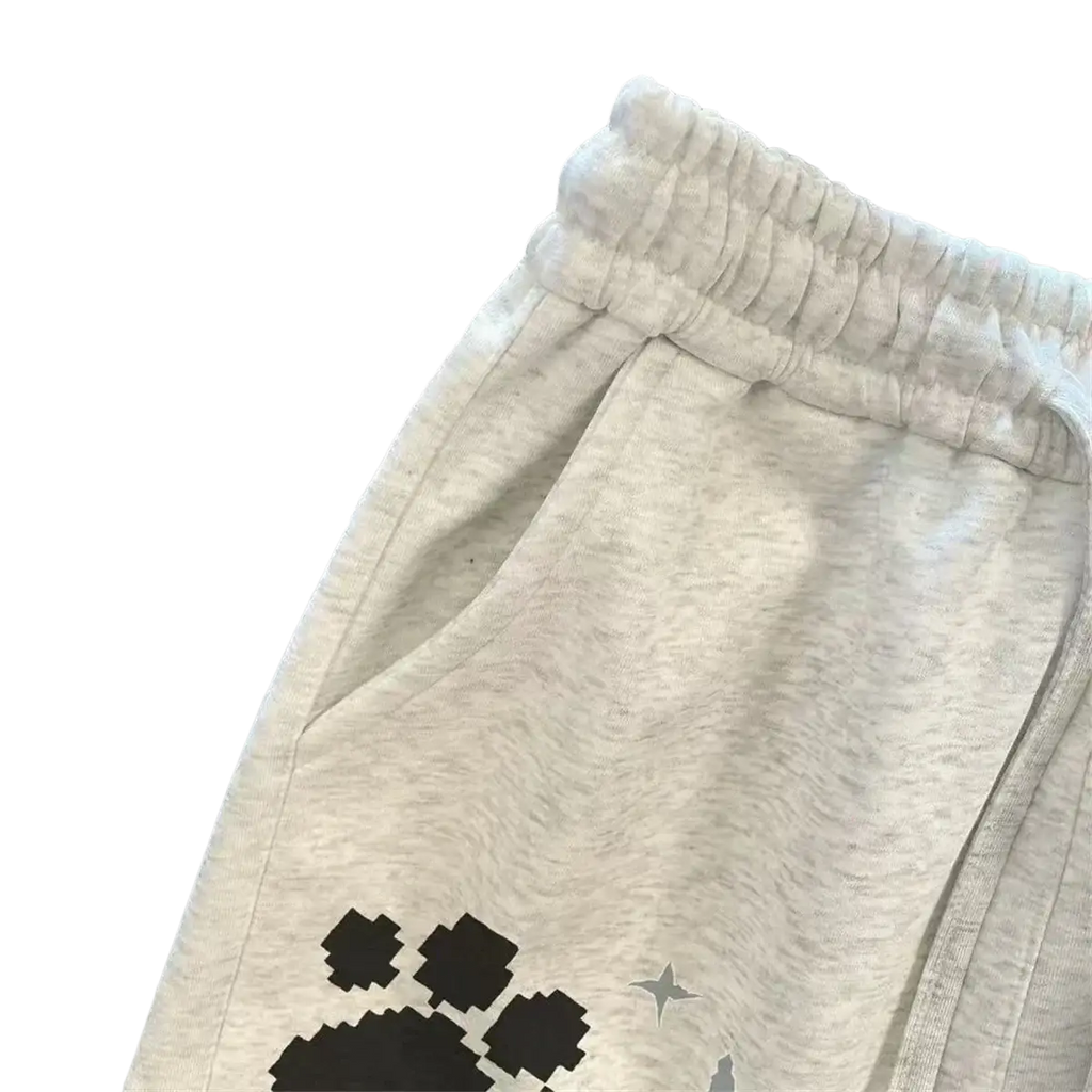Light gray heathered sweatpants with black pixelated paw print and silver star graphic on the leg for women