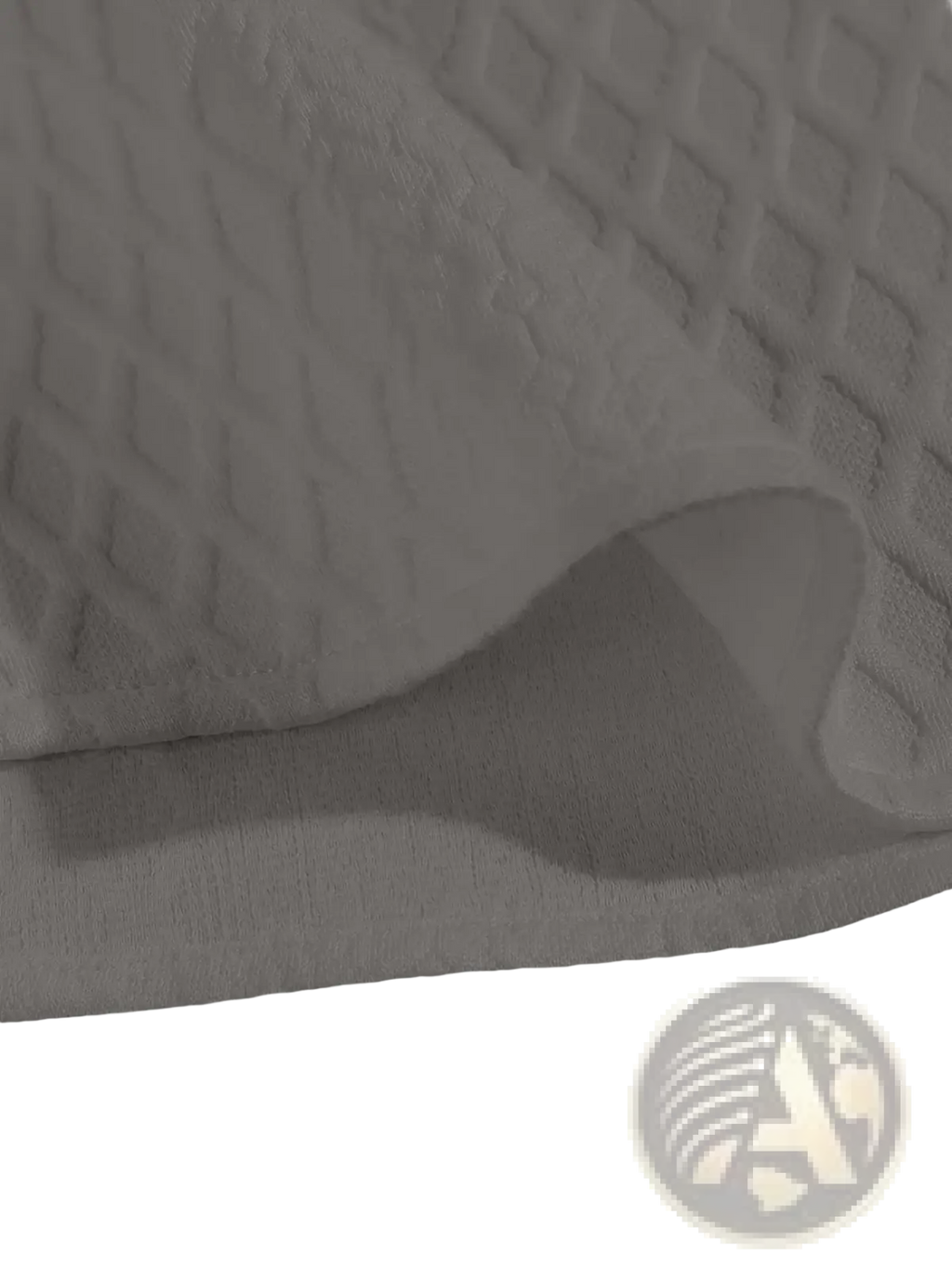 White quilted fabric with diamond pattern on the back of a gray diamond knit short sleeve shirt
