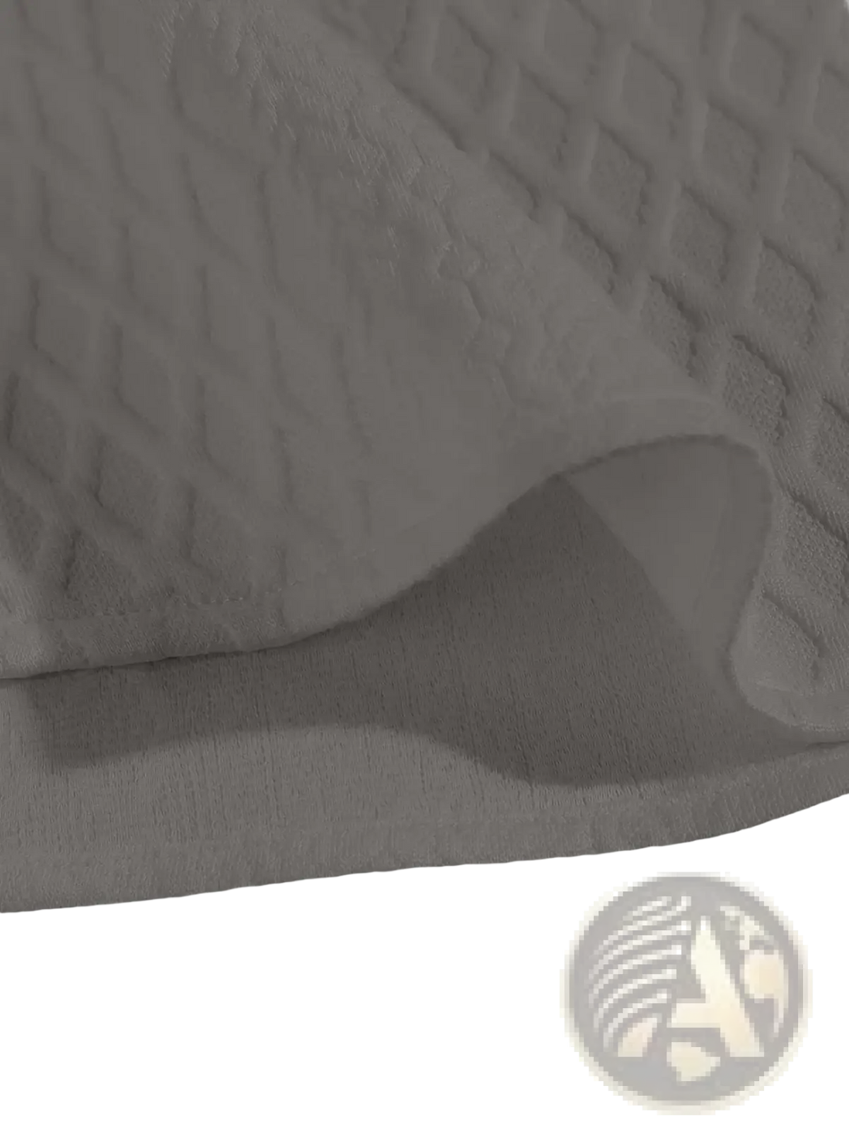 White quilted fabric with diamond pattern on the back of a gray diamond knit short sleeve shirt