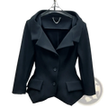 Black blazer with structured tailored fit and notched lapels paired with gray high waisted knee length pencil skirt