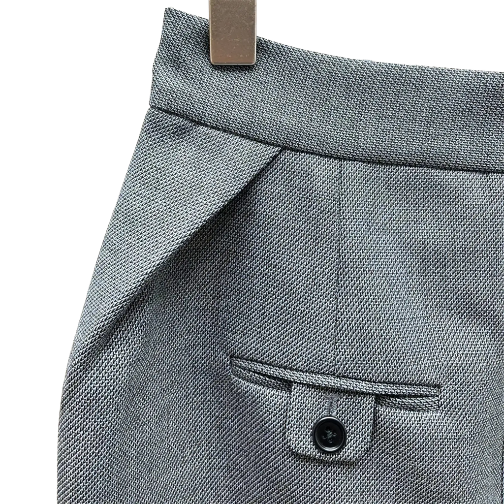 Gray high waisted pencil skirt in wool with subtle herringbone texture and black button on front pocket