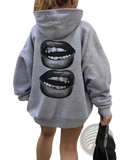 Gray lips print pullover hoodie featuring a bold black graphic of stylized lips with teeth and metallic accents