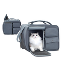 Gray breathable pet carrier travel bag with mesh-lined opening and multiple compartments for small cats and dogs