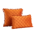 Orange velvet pillow covers with diamond-quilted pattern and pom-pom trim receiving positive feedback