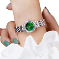 A sleek silver-toned green dial luxury stainless steel quartz women watch with minimalist hour markers and link bracelet