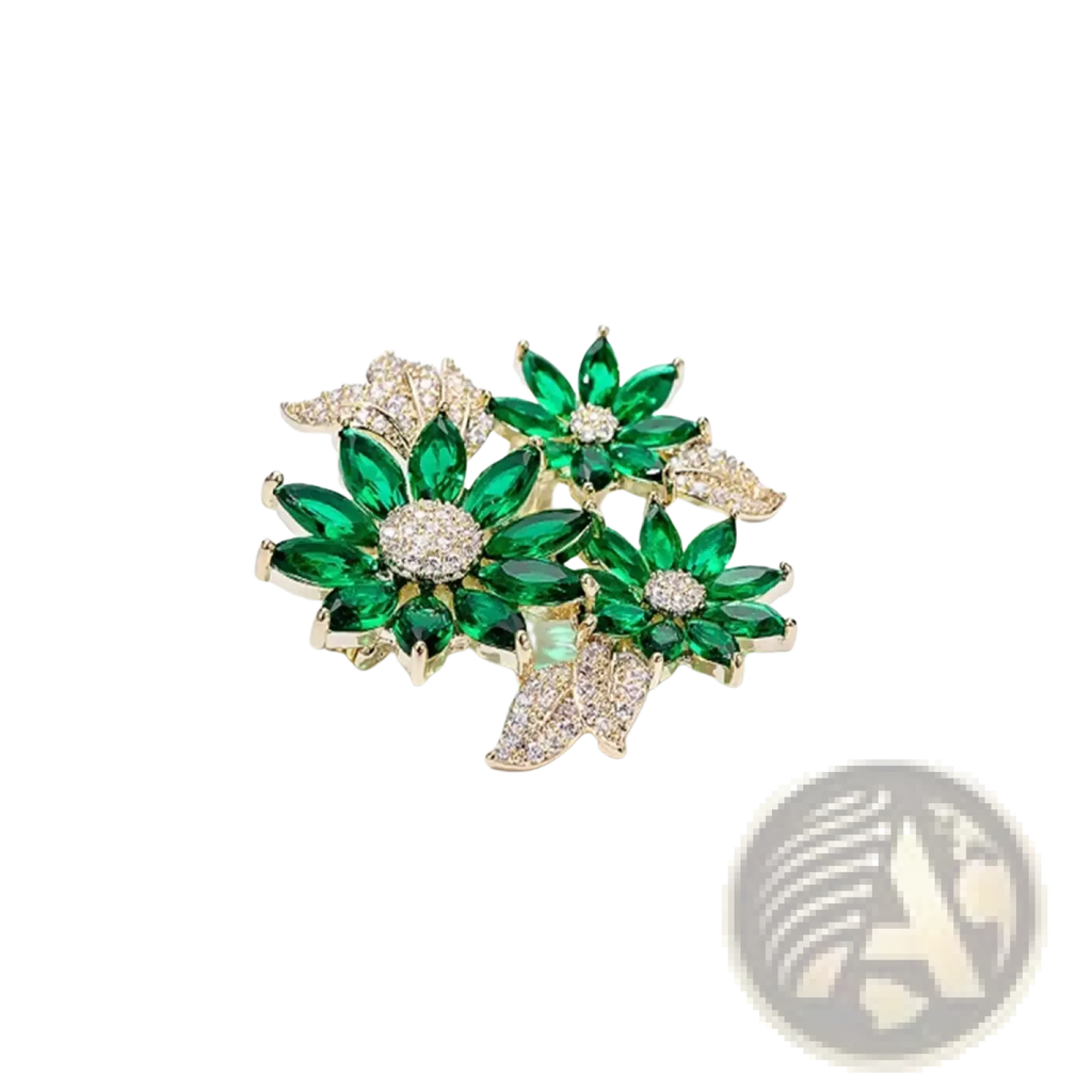 A sparkling green and gold floral rhinestone brooch pin with emerald-cut crystals and pave-set diamonds