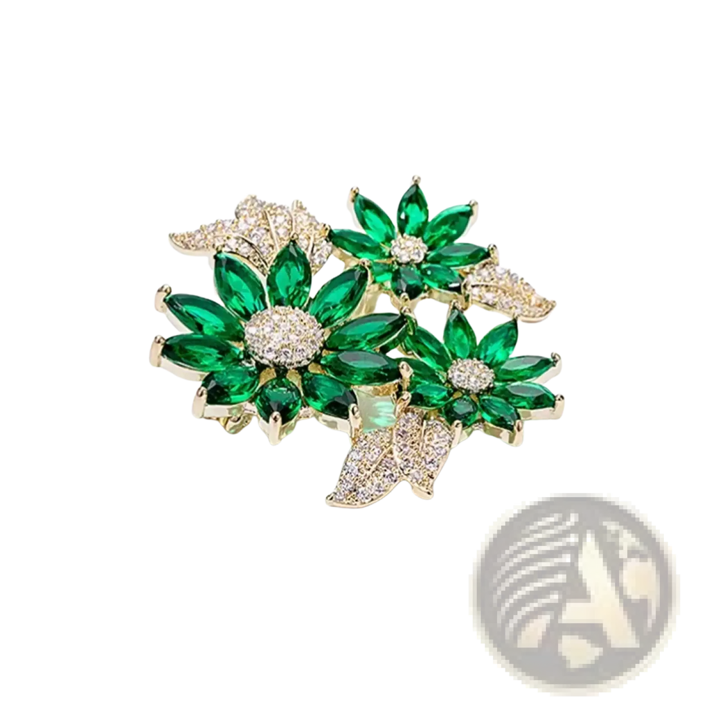 A green floral rhinestone brooch pin sparkling with green and gold tones featuring emerald-cut crystals and pave-set diamonds