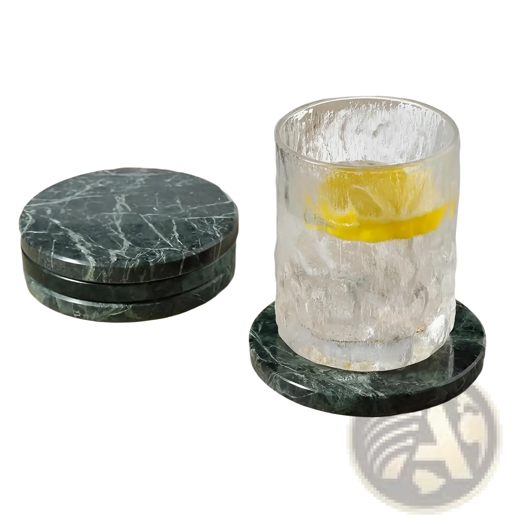 A clear textured glass tumbler with lemon and ice on a dark green marble stone coaster from a set of 4