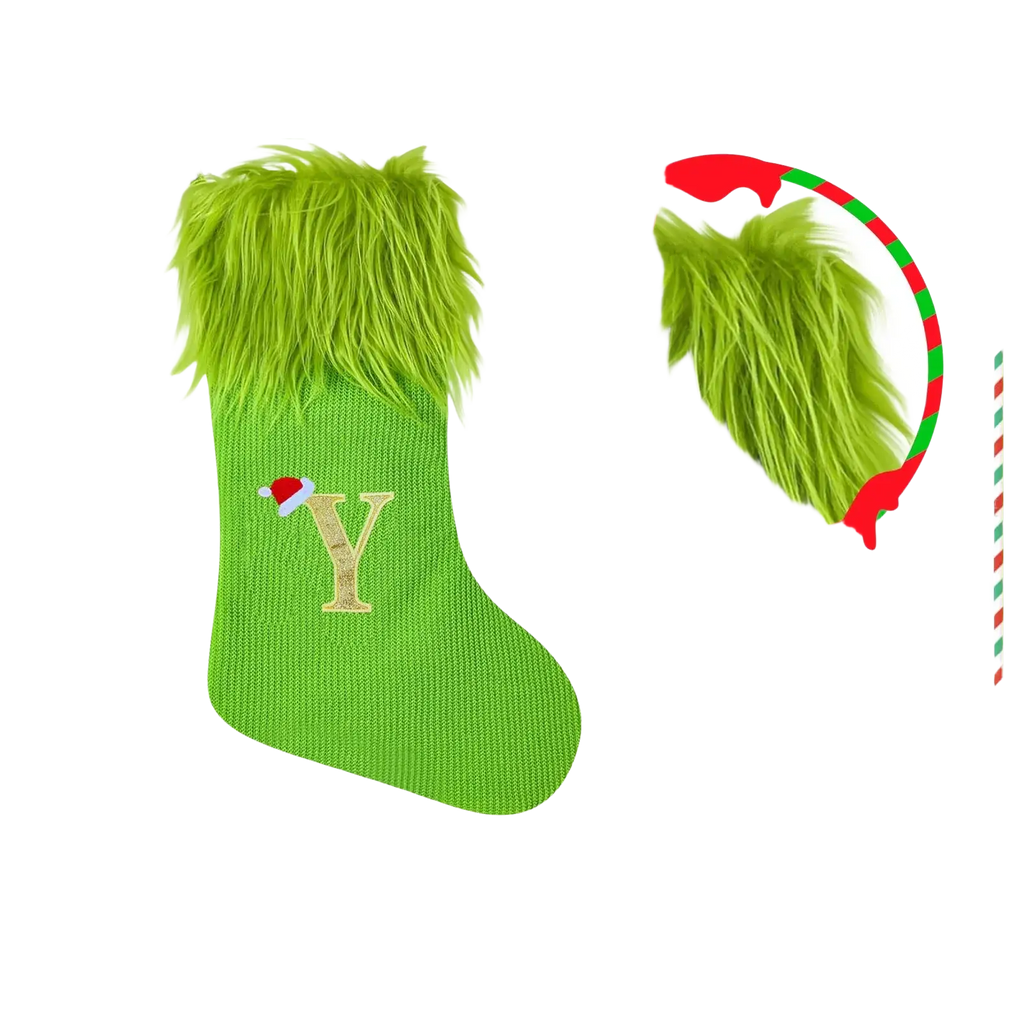 Green knitted christmas stocking with fluffy faux fur cuff and gold embroidered letter y topped with small red santa hat