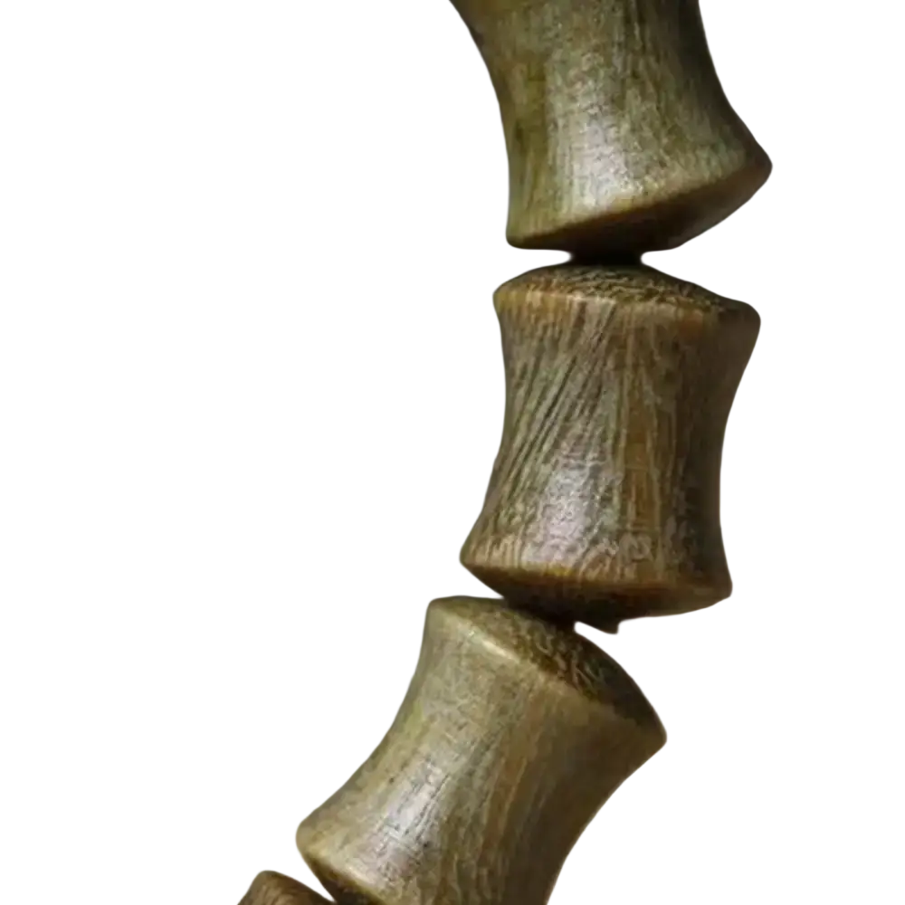 A close-up of a dark green sandalwood hand bracelet with cylindrical beads and visible grain patterns