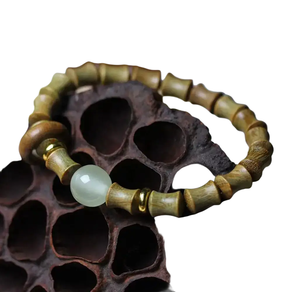 A green sandalwood hand bracelet featuring natural bamboo segments and a pale green jade bead with gold spacers