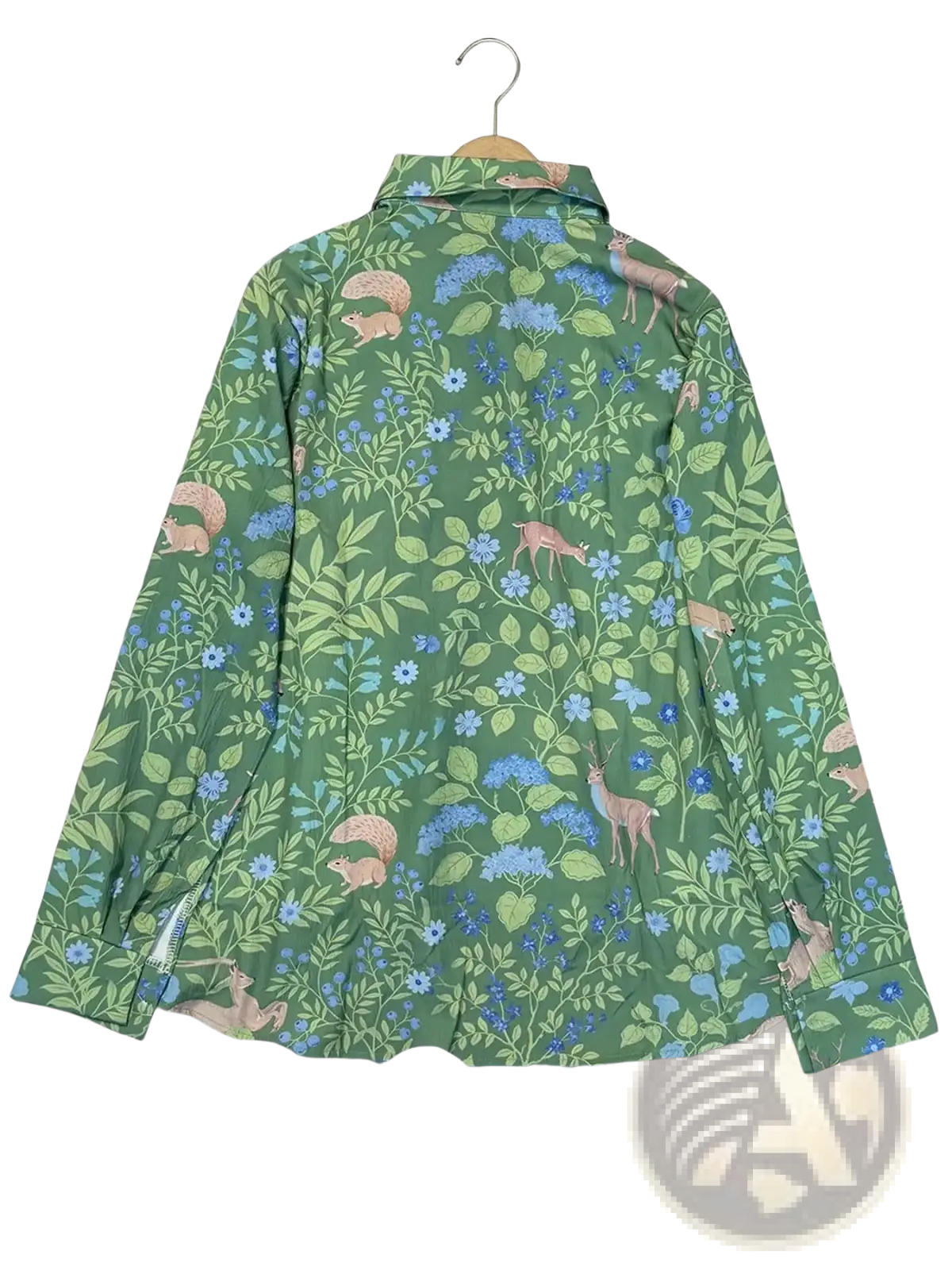 Green woodland print long sleeve shirt with deer, squirrels, and blue flowers in a button-up design
