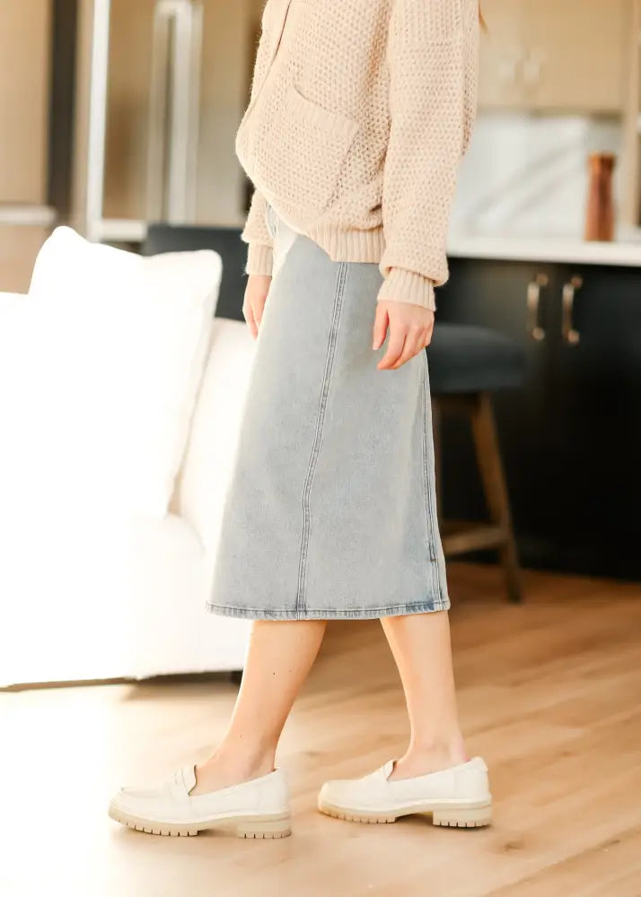 Greta light wash button front denim midi skirt with straight cut and visible stitching along the seams