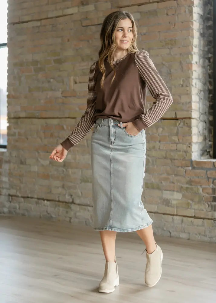 Greta light wash button front denim midi skirt in light-wash denim with a straight cut and visible stitching
