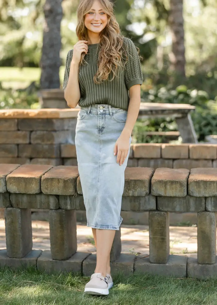 Olive green ribbed knit short-sleeve top paired with light wash button front denim midi skirt front view