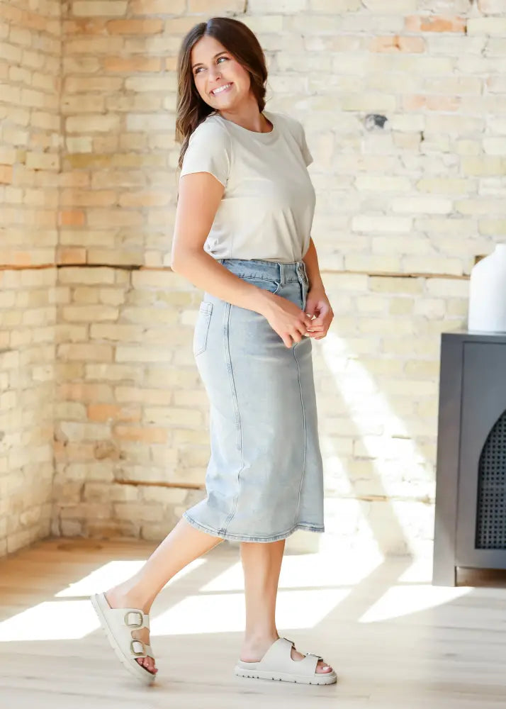 Greta light wash button front denim midi skirt with straight cut and belt loops in light-wash denim material
