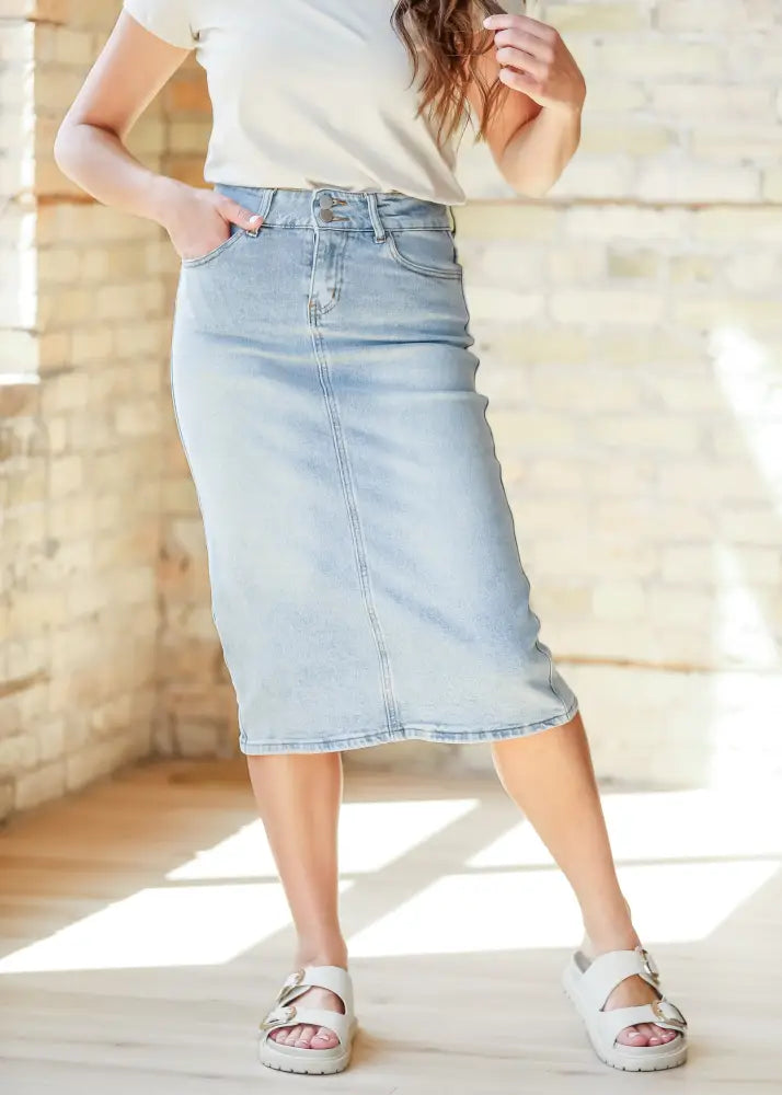Greta light wash button front denim midi skirt in light-wash with a classic straight-leg cut and button closure