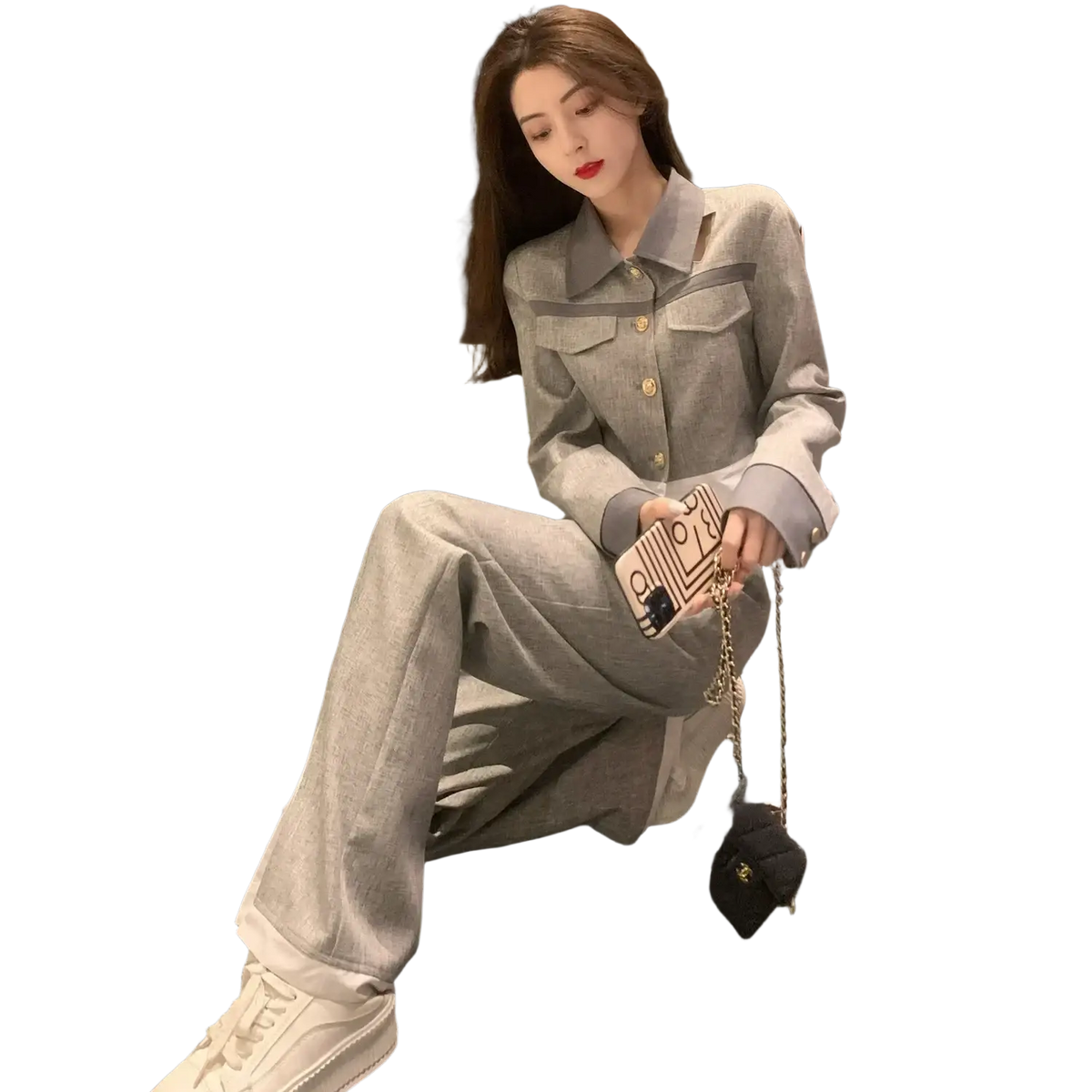 A beige phone case with a black cat design and gold chain strap complements the grey denim two piece suit wide leg pants