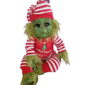 A plush green grinch stuffed toy wearing a red and white striped hat and onesie with christmas my fav print