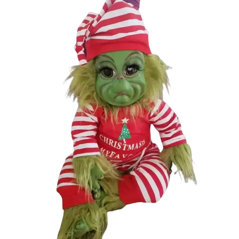 A plush green grinch stuffed toy wearing a red and white striped hat and onesie with christmas my fav print