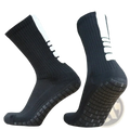 Black grip soccer socks with white side stripes and textured non slip soles designed for athletic use