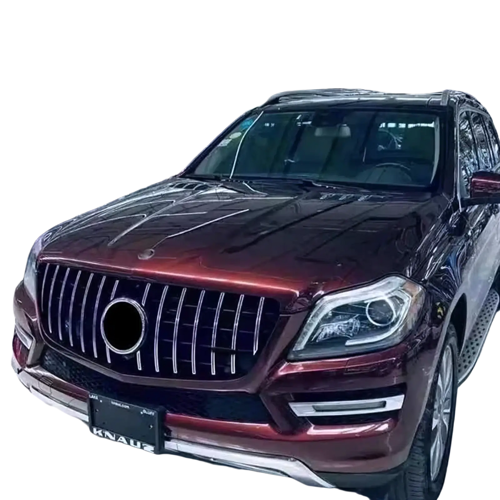 A glossy maroon Mercedes Benz X166 SUV with a custom chrome GTR front grille featuring vertical slats and a central emblem