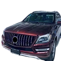 A glossy maroon Mercedes Benz X166 SUV with a custom chrome GTR front grille featuring vertical slats and a central emblem