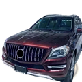 A glossy maroon Mercedes Benz X166 SUV with a custom chrome GTR front grille featuring vertical slats and a central emblem