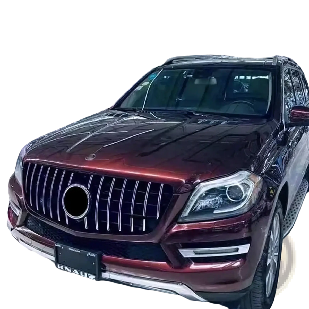 A glossy maroon Mercedes Benz X166 SUV with a custom chrome GTR front grille featuring vertical slats and a central emblem