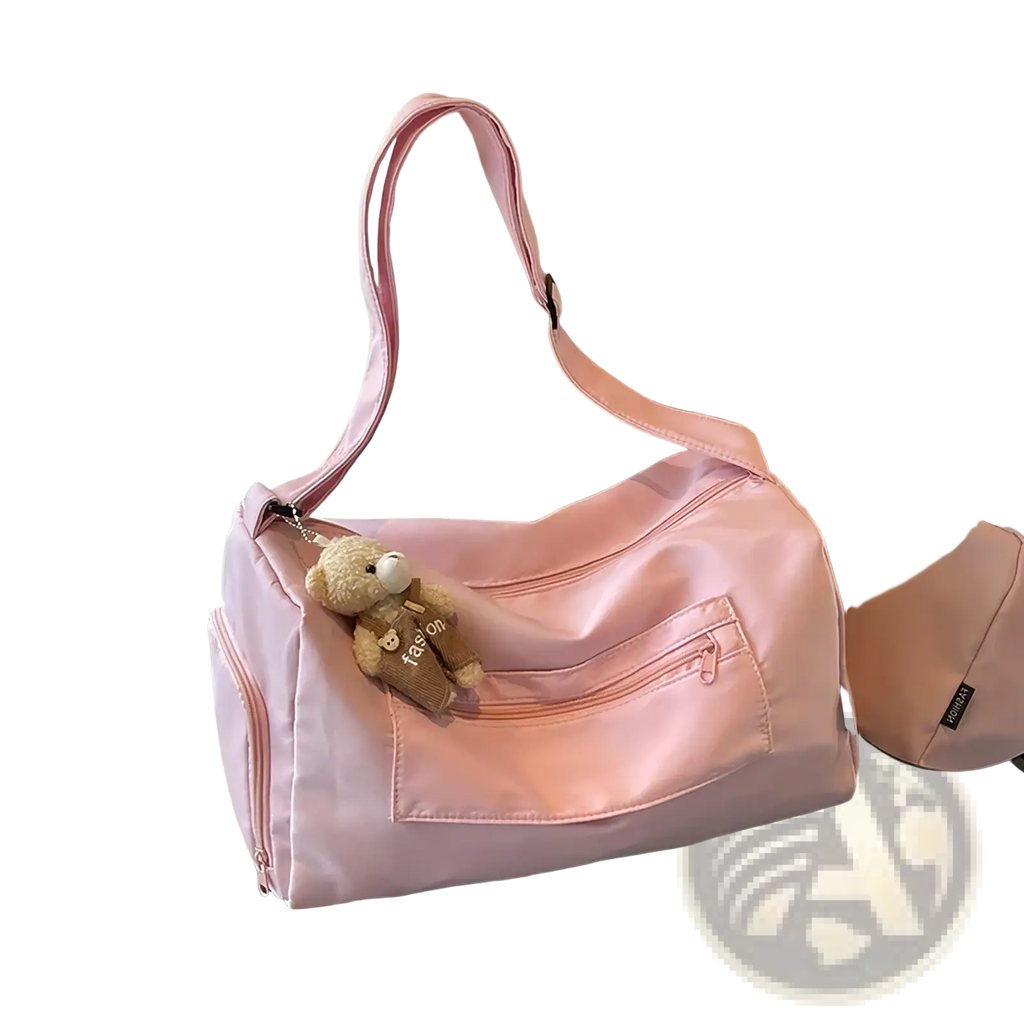 Pink nylon gym duffle bag with plush teddy bear keychain suitable for travel and featuring a mint green travel pillow bag