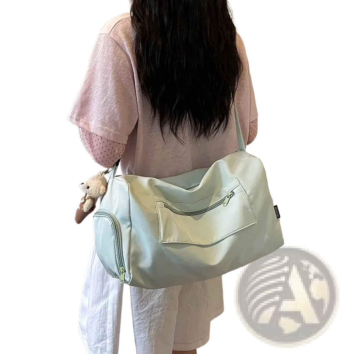A soft mint green canvas gym duffle bag with a front zippered pocket and a plush toy attached on the side