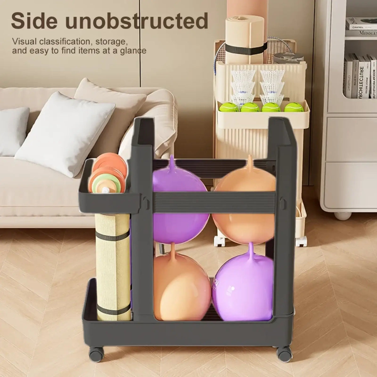 Black plastic gym equipment organizer trolley with wheels and multiple compartments holding colorful exercise balls