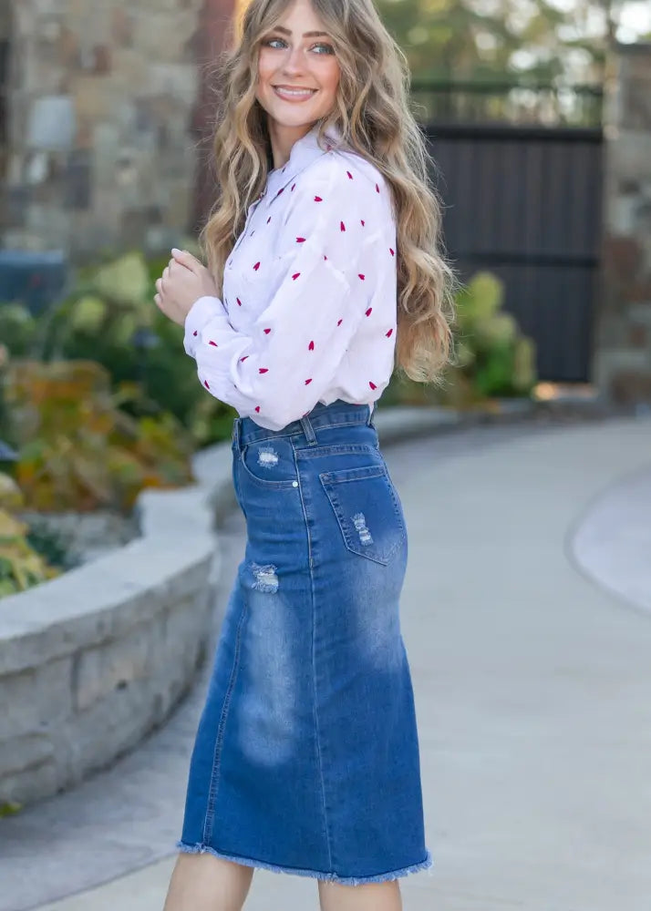 Hadley high rise distressed denim midi skirt in blue with a frayed hem and mid-thigh length design