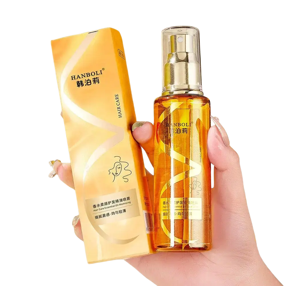 A golden transparent spray bottle labeled hanboli hair care essential oil for dry frizzy hair with silver pump