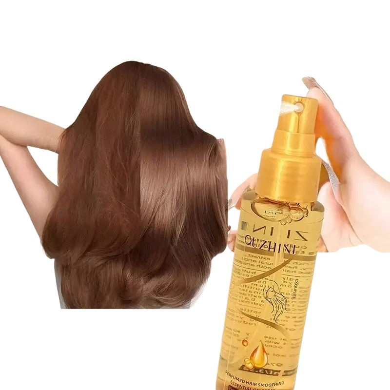 Golden hair care essential oil spray bottle with sleek transparent body and gold nozzle for luster and repair
