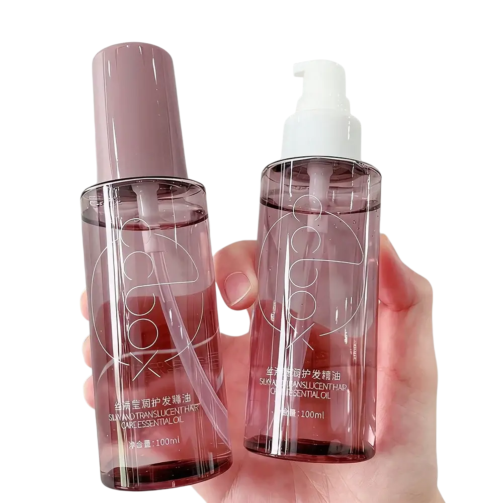 Two translucent pink glass bottles of hair care nourishing repair serum with matte rose gold cap and white pump dispenser