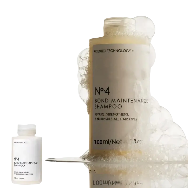 A translucent no4 bond maintenance shampoo bottle with gold cap from hair care series for frizz repair split ends control