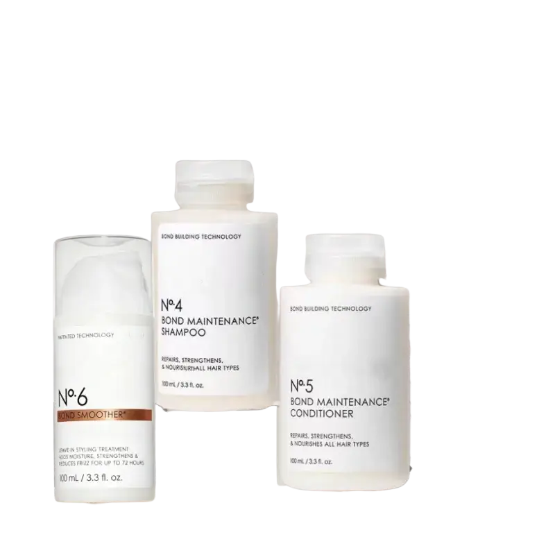 White cylindrical bottles with minimalist labels from hair care series for frizz repair split ends control bond smoother shampoo and conditioner