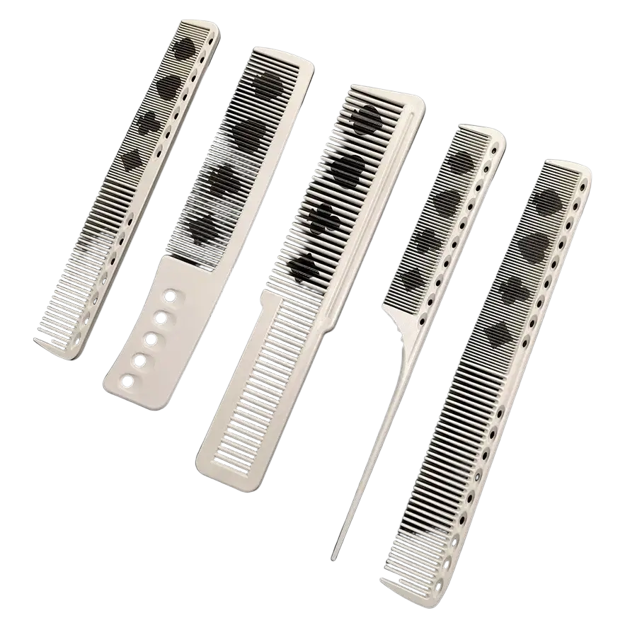 Set of five white resin hair cutting combs with black playing card suit patterns and perforated handles