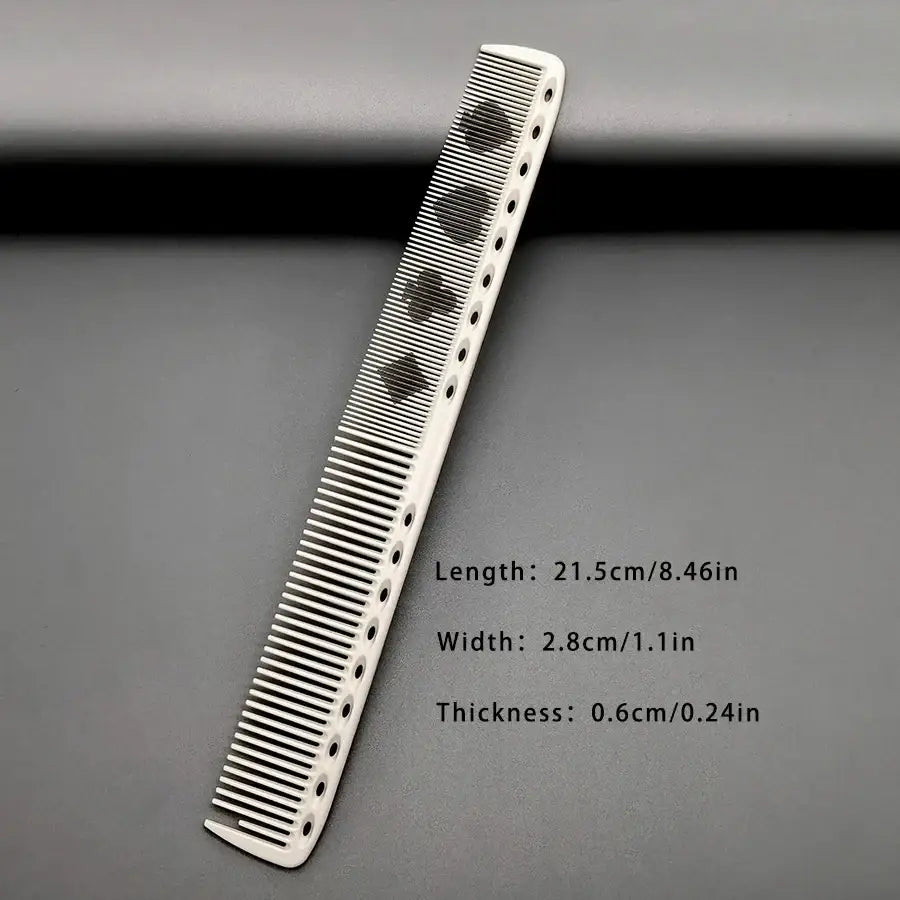 White resin hair cutting comb with black spade-shaped cutouts for precise styling and hair trimming tasks