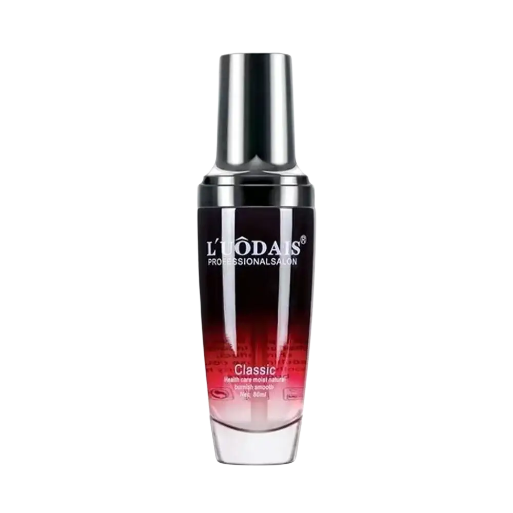 A sleek red to black glass 80ml hair essential oil bottle with metallic cap labeled l’uodais professional for hair loss and frizzy hair