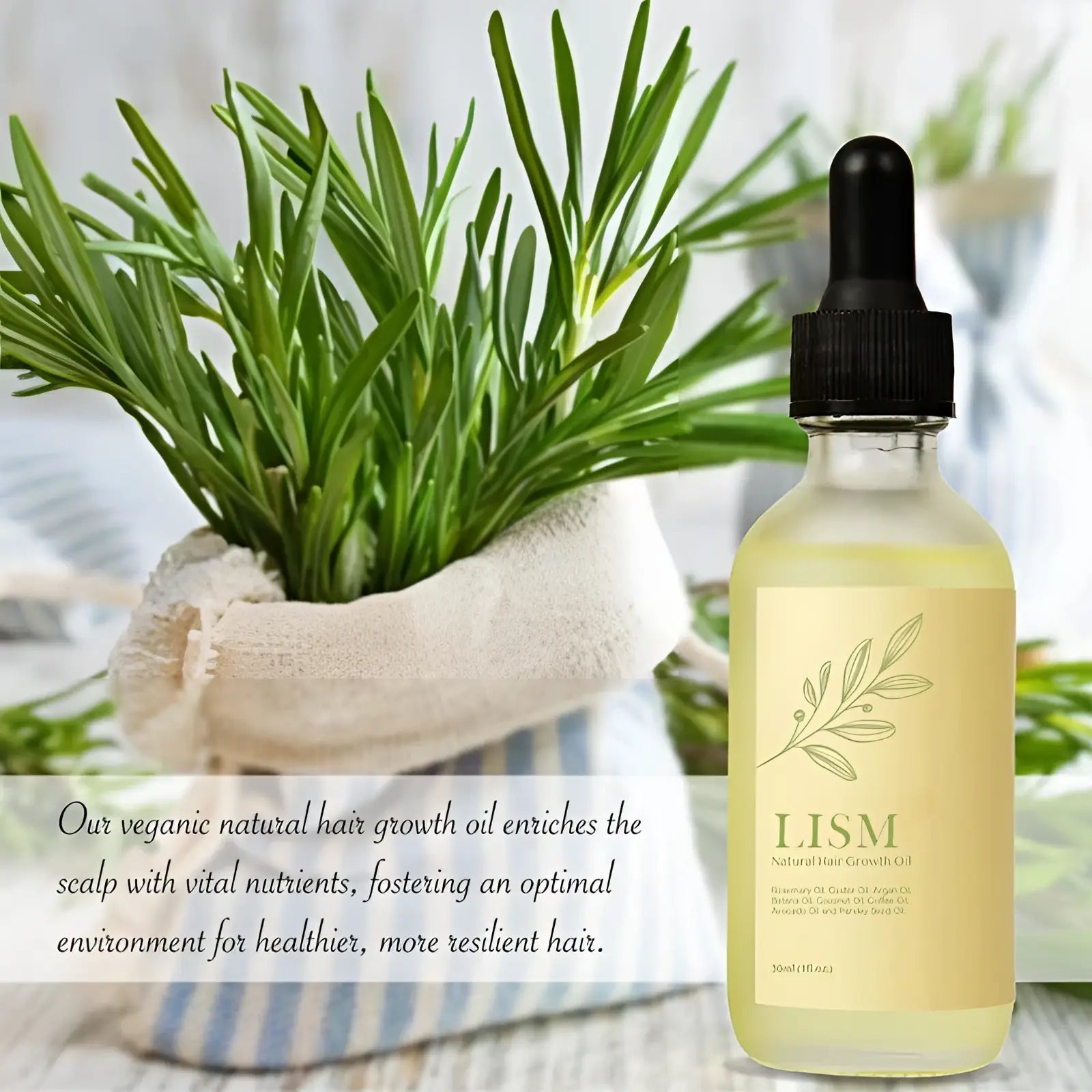 A clear glass bottle of iism natural pale yellow hair growth oil with black dropper cap and olive branch label