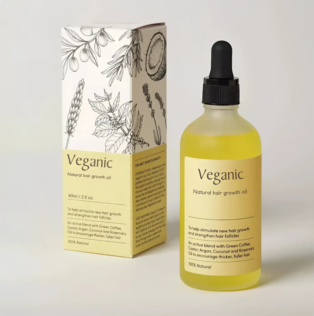 Veganic hair growth oil vegan natural essential treatment in a clear glass bottle with black dropper cap and golden-yellow liquid
